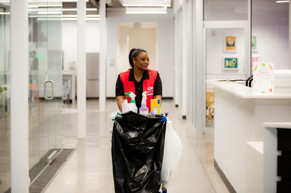 A cleaning service professional with equipment in a commercial office